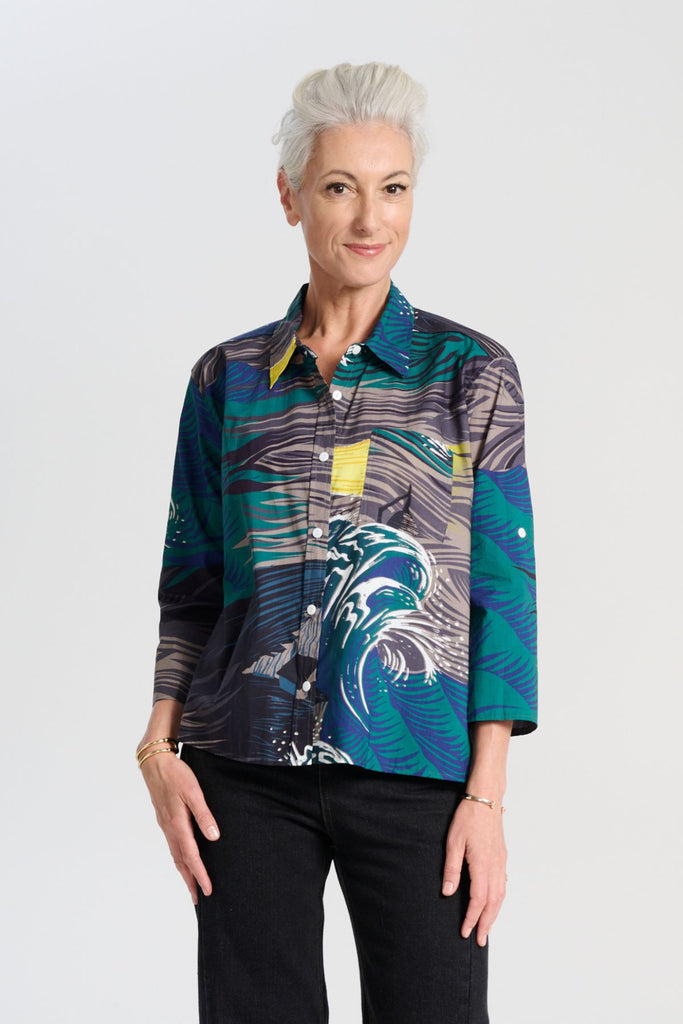 Olga de Polga classic cotton shirt in the Storm grey and blue printed Isla print on 100% cotton. The front of the shirt sits at the waist while the back falls to the hips for a lovely drape. Front view on model.