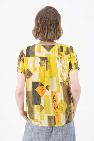 Olga de Polga Classic tee top in the Casco lime green Splice printed seersucker fabric. Round neck. Short sleeves, loose boxy fit. Back view on model.