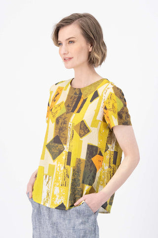 Olga de Polga Classic tee top in the Casco lime green Splice printed seersucker fabric. Round neck. Short sleeves, loose boxy fit. Side view on model.