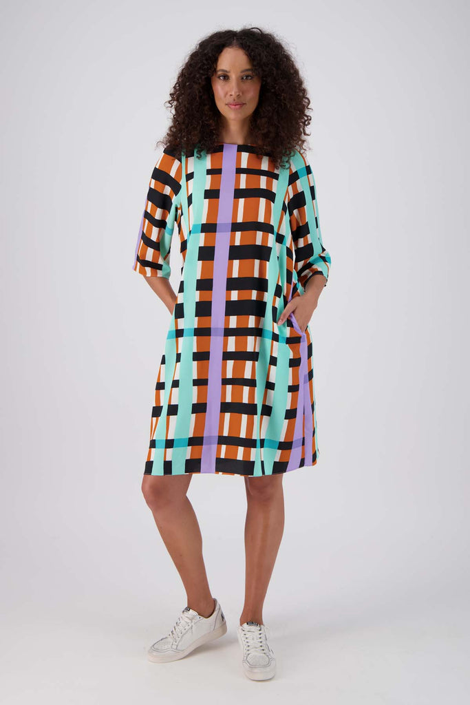 Olga de Polga multi coloured geometric printed Madras shift dress. Front full length view on model.