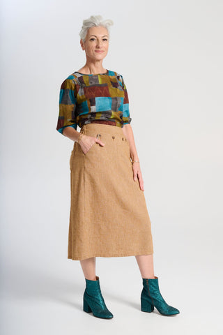 Olga de Polga Hepburn Haven skirt in Mustard wool/linen. Sid front view on model.