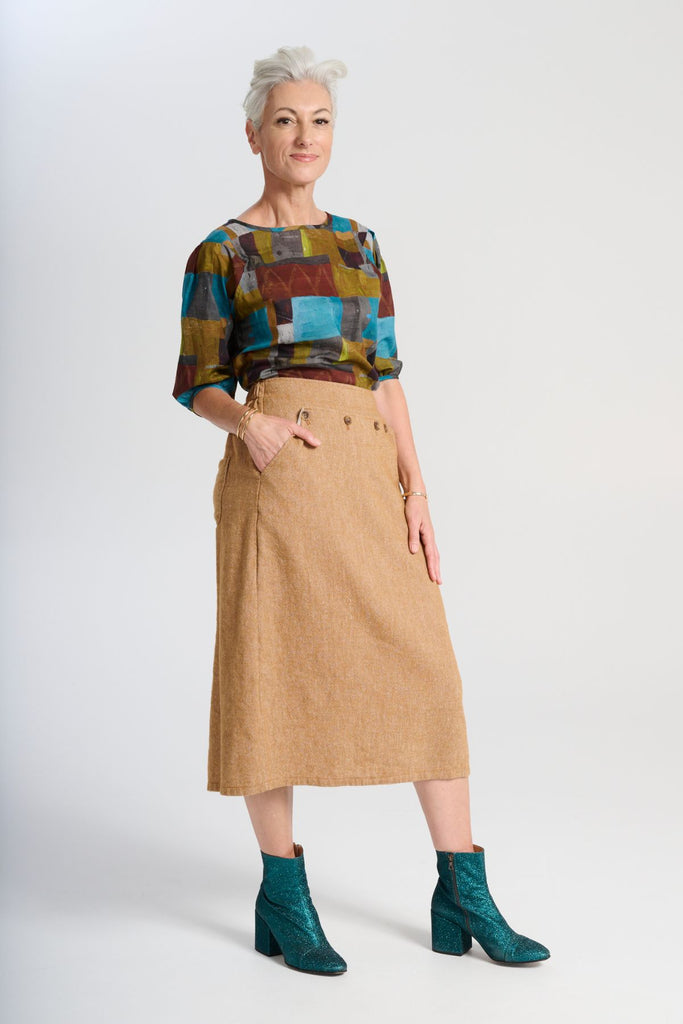 Olga de Polga Hepburn Haven skirt in Mustard wool/linen. Sid front view on model.