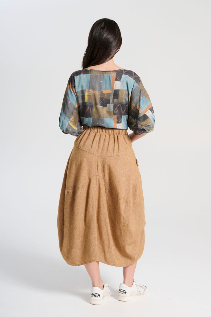 Olga de Polga Mustard Milwaukee Haven skirt in a wool/linen blend. Comfy waistband making it the perfect throw-on-and-go! Back view on model.