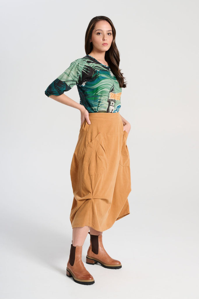 Olga de Polga Milwaukee Marlowe skirt in Mustard fine cotton cord. Comfy waistband making it the perfect throw-on-and-go! Side front view on model