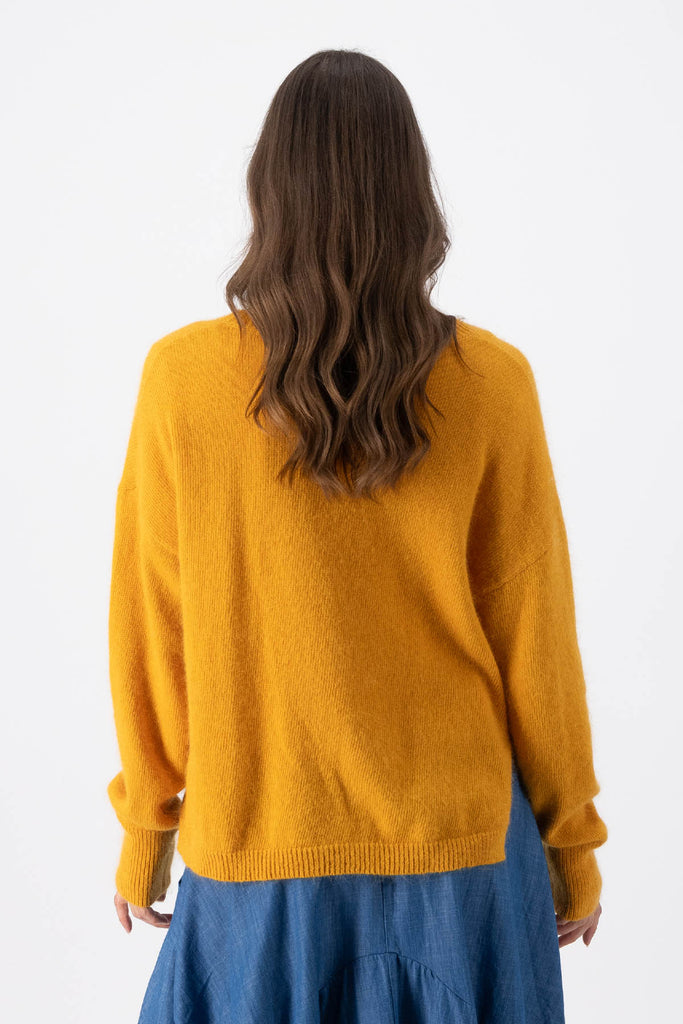 Olga de Polga Mustard Portland sweater in an angora/wool fabrication. With a round neck and slightly cropped length, the sweater has long sleeves.  Back view