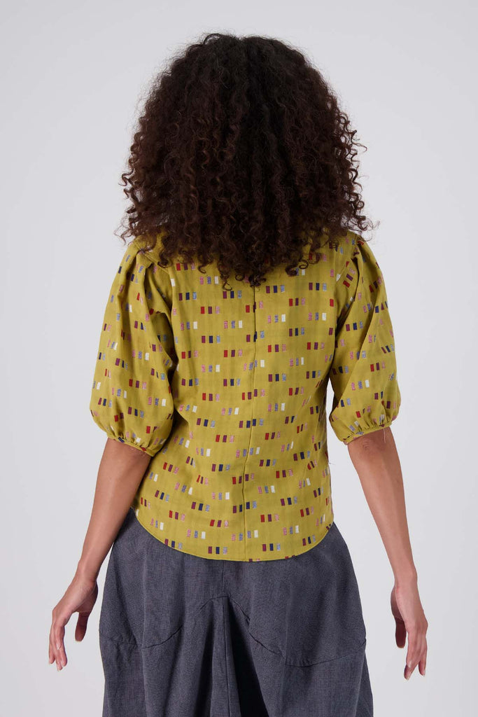 Olga de Polga Mustard Telegraph Blouse in woven cotton.  Back view on model