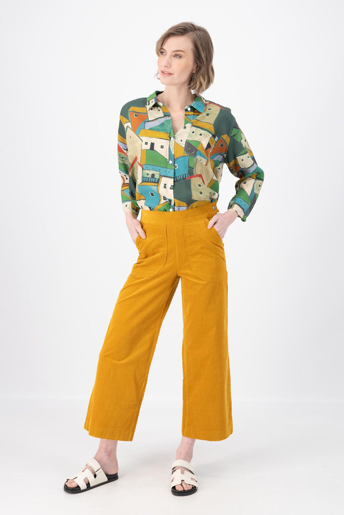 Olga de Polga Peggy Pants in Mustard Yellow fine cotton cord. Cropped length, large front patch pockets, elasticated waistband, side zip fastening. Front full length view on model.