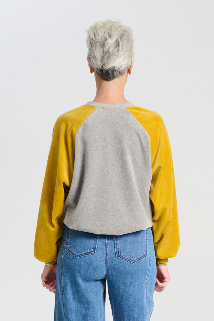 Olga de Polga Mustard and grey Odessa Sweatshirt in soft cotton velvet.  Back view on model