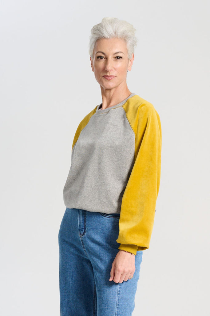 Olga de Polga Mustard and grey Odessa Sweatshirt in soft cotton velvet. Side front view on model