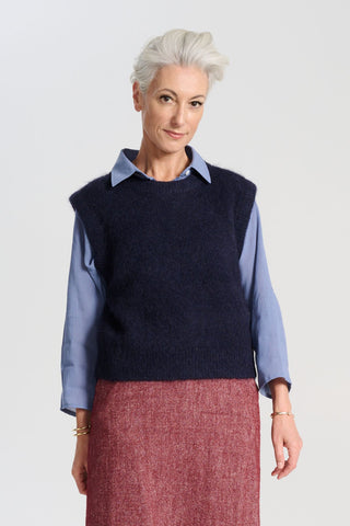 Olga de Polga Navy Aspen alpaca knit vest. Ribbing at neckline and hem. A beautifully textured knit vest—your perfect layering essential for effortless, trans-seasonal styling. Front view on model