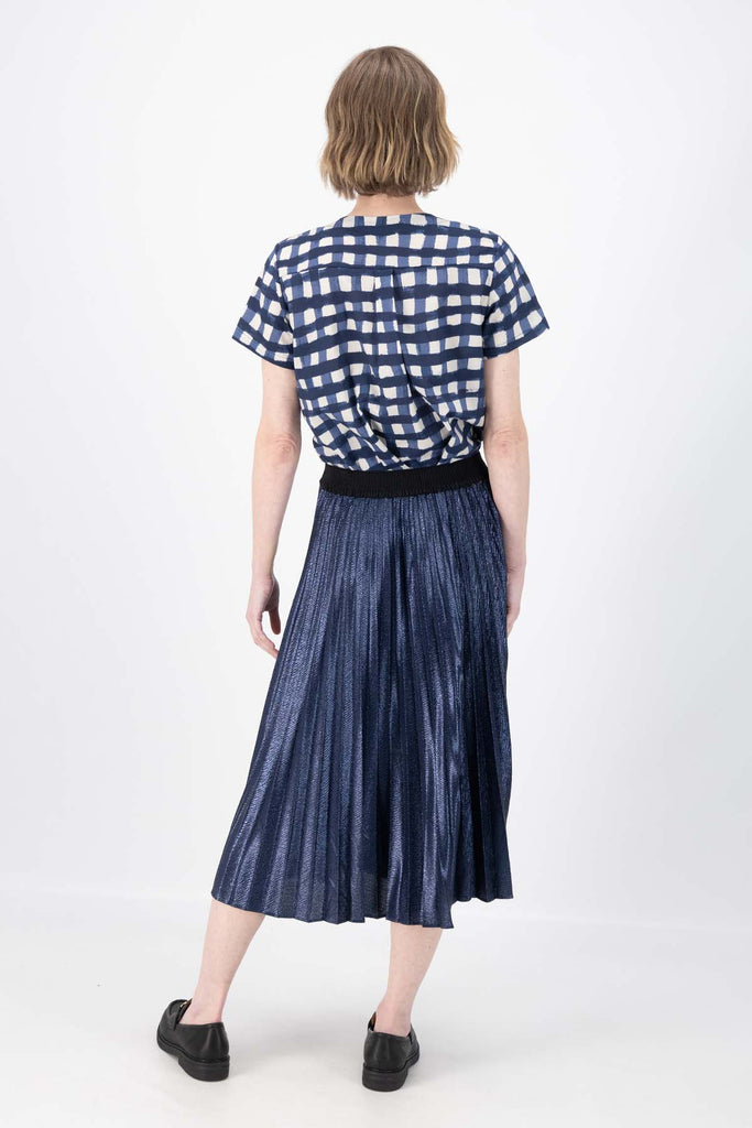 Olga de Polga Navy Champagne pleated skirt in 100% recycled polyester. back view on model.