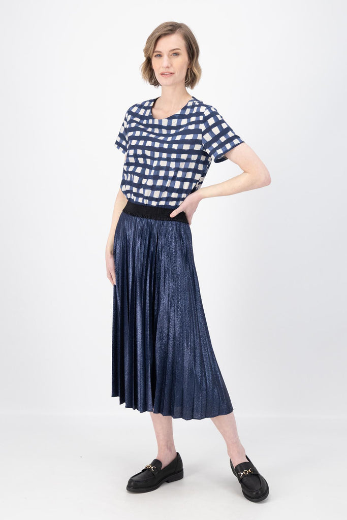 Olga de Polga Navy Champagne pleated skirt in 100% recycled polyester. Side front full length view on model.