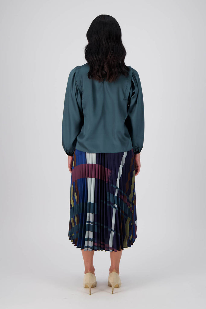 Olga de Polga pleated skirt in our Crossroads Woodlands printed recycled polyester. elasticated waistband. Midi length. Back full length view on model