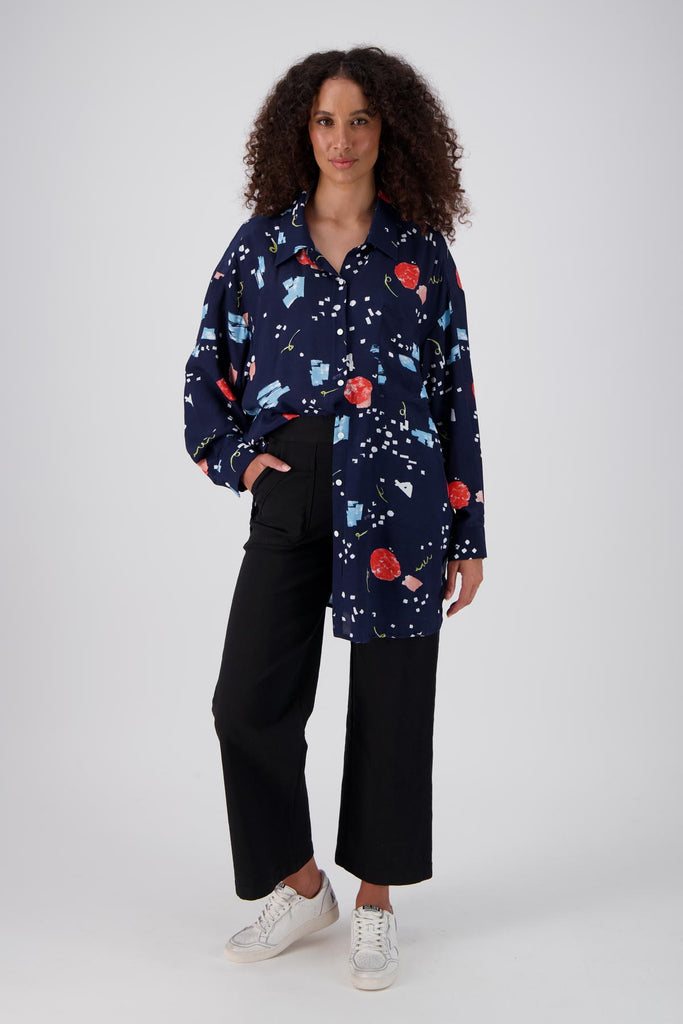 Olga de Polga LAX shirt in an oversized fit with long sleeves and button down front. Tie at the waist or wear loose over a t-shirt. Full length view on model