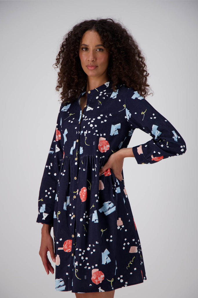 Olga de Polga navy Galaxy printed cotton cord tunic dress. Perfect transeasonal dress with long sleeves and a round neckline. Side front view on model