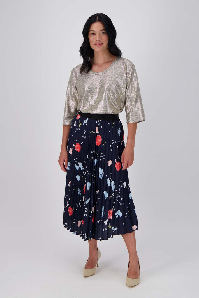 Olga de Polga Navy Galaxy printed skirt in 100% recycled polyester. Elasticated waistband and permanent pleats. Front full view on model.