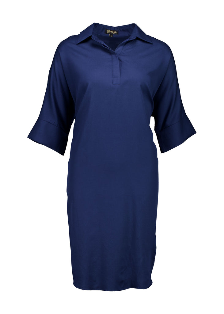 Olga de Polga Marianna Estilo dress in Navy. Shirt dress with bat-wing sleeves and a collar with short button opening at the front. Finishes above the kneed depending on height. Front view.