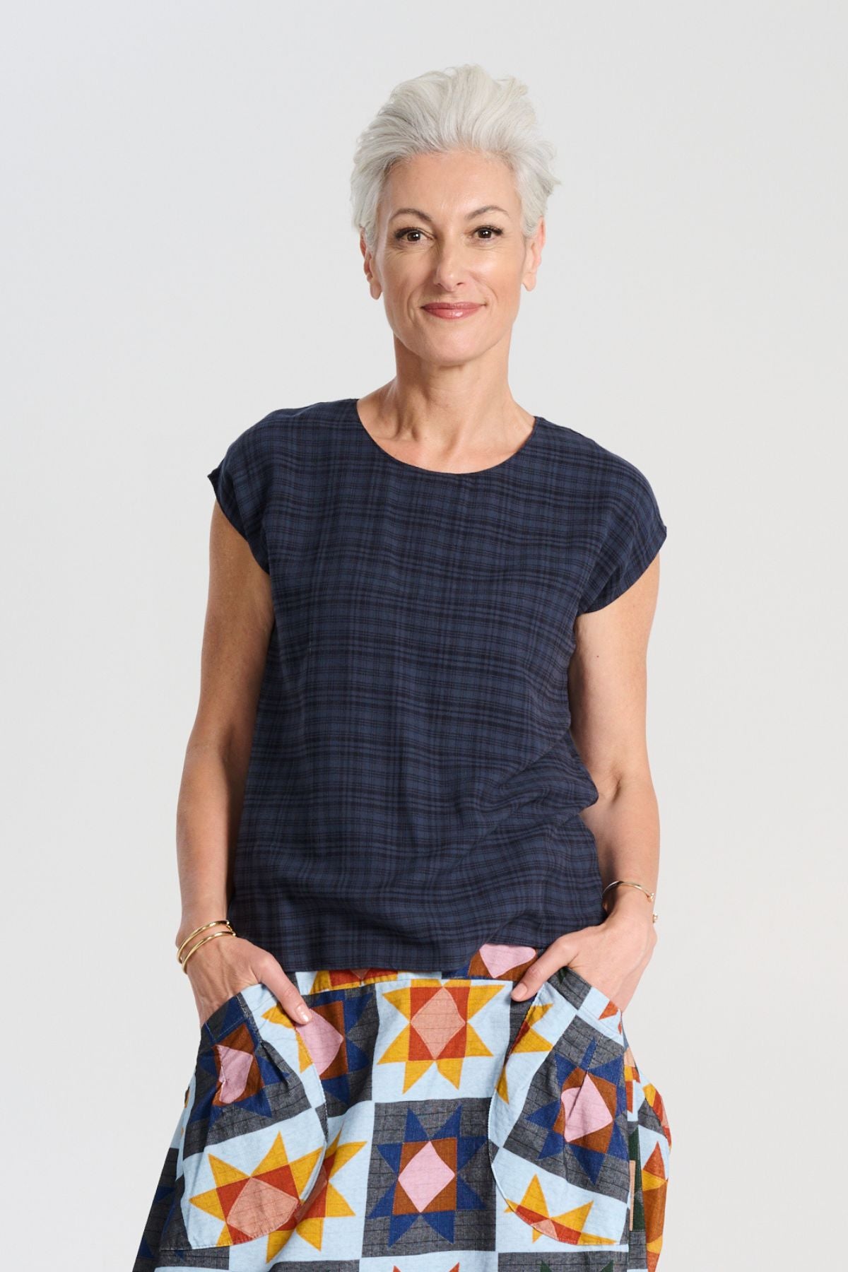 Olga de Polga Ella tee in navy Midnight brushed cotton seersucker. Straight cut with slight tapering to the waist, and cap sleeves. Front view on model