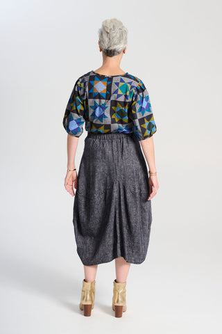 Olga de Polga Navy Milwaukee skirt in Haven wool/linen. Our Milwaukee Haven Skirt in the Navy wool/linen blend is an incredibly unique, chic and original skirt. It is universally flattering, highly versatile, and super comfortable. Back view on model