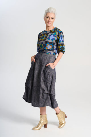 Olga de Polga Navy Milwaukee skirt in Haven wool/linen. Our Milwaukee Haven Skirt in the Navy wool/linen blend is an incredibly unique, chic and original skirt. It is universally flattering, highly versatile, and super comfortable. Side front view on model