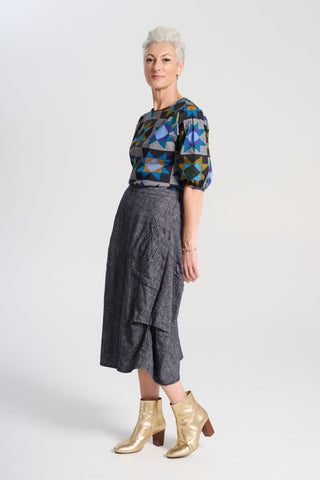 Olga de Polga Navy Milwaukee skirt in Haven wool/linen. Our Milwaukee Haven Skirt in the Navy wool/linen blend is an incredibly unique, chic and original skirt. It is universally flattering, highly versatile, and super comfortable. Side view on model