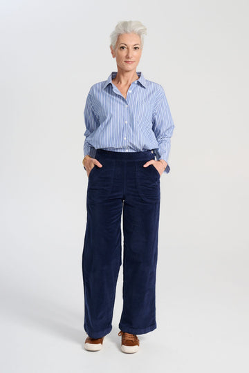 Olga de Polga Peggy Paris Pants Long in Navy soft velvet. Full length, wide leg pants with a back elasticated waistband. Front view on model.