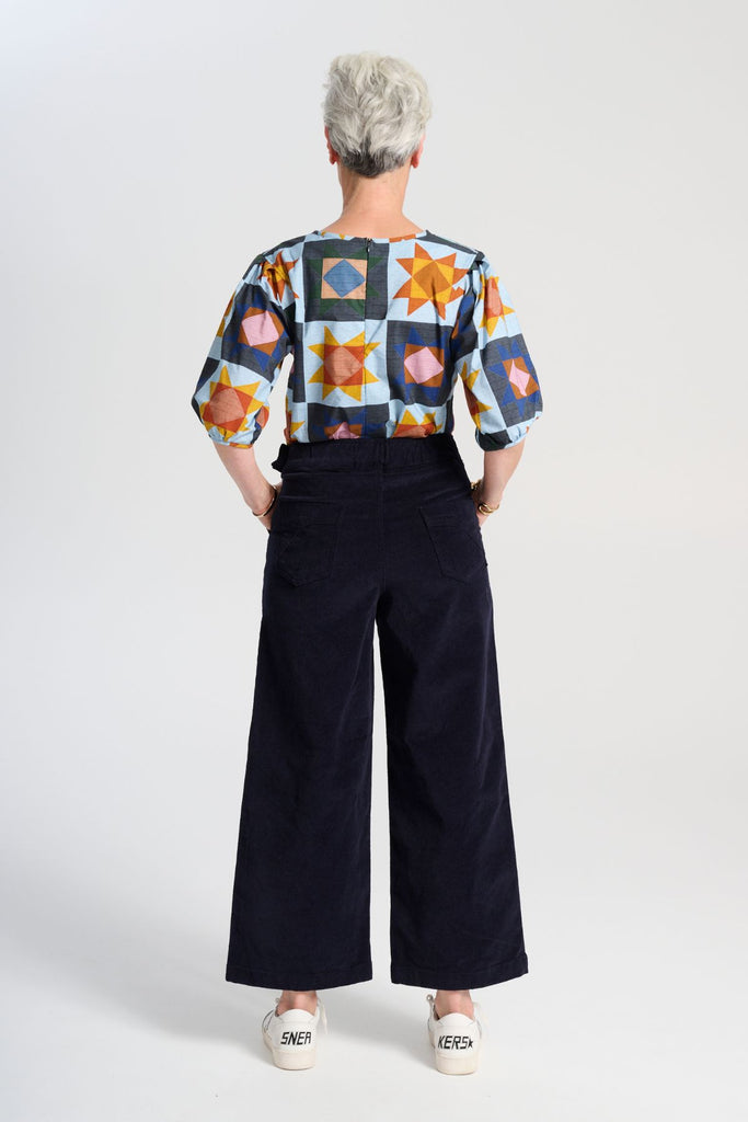 Olga de Polga Peggy Sue Pants cropped, in navy cotton velvet corduroy. Wide legged. Large patch pockets. Back view on model