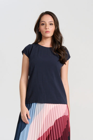 Olga de Polga Navy tencel Rhea tee. With a round neckline and cap sleeves this tee is perfect for all occasions. Button fastening at back neck. Front close up view on model.