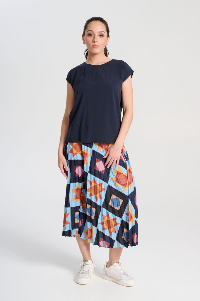 Olga de Polga Navy tencel Rhea tee. With a round neckline and cap sleeves this tee is perfect for all occasions. Button fastening at back neck. Front full length view