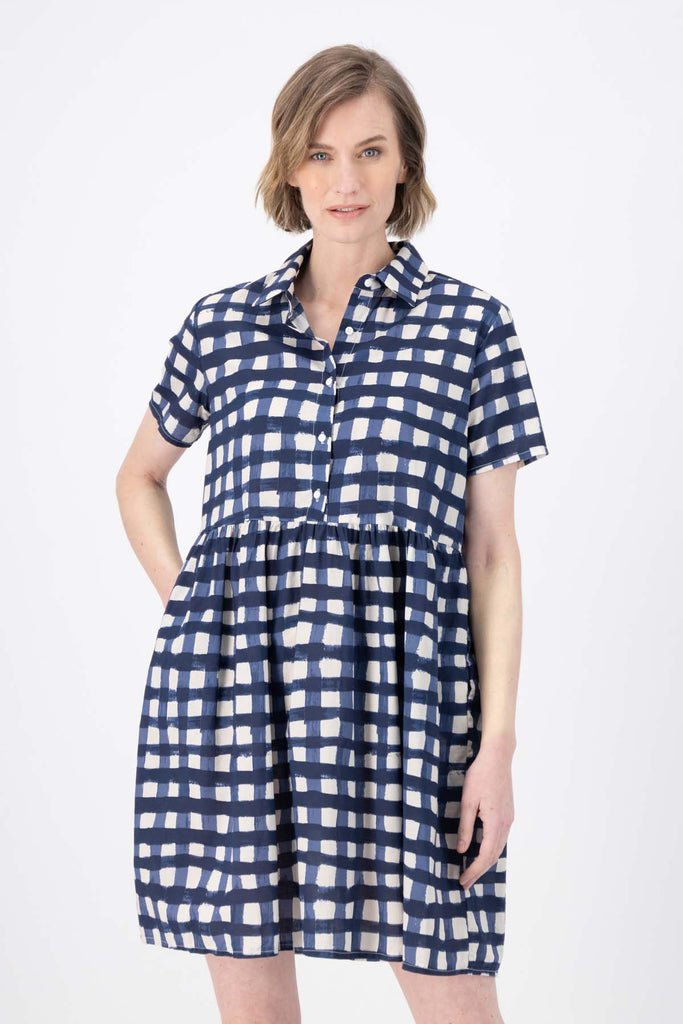 Olga de Polga's Villa drop waist dress in Rosa Navy printed 100% cotton fabric. Short sleeves, button front, collar, finishes at the knee, depending on height. Front close-up view on model.