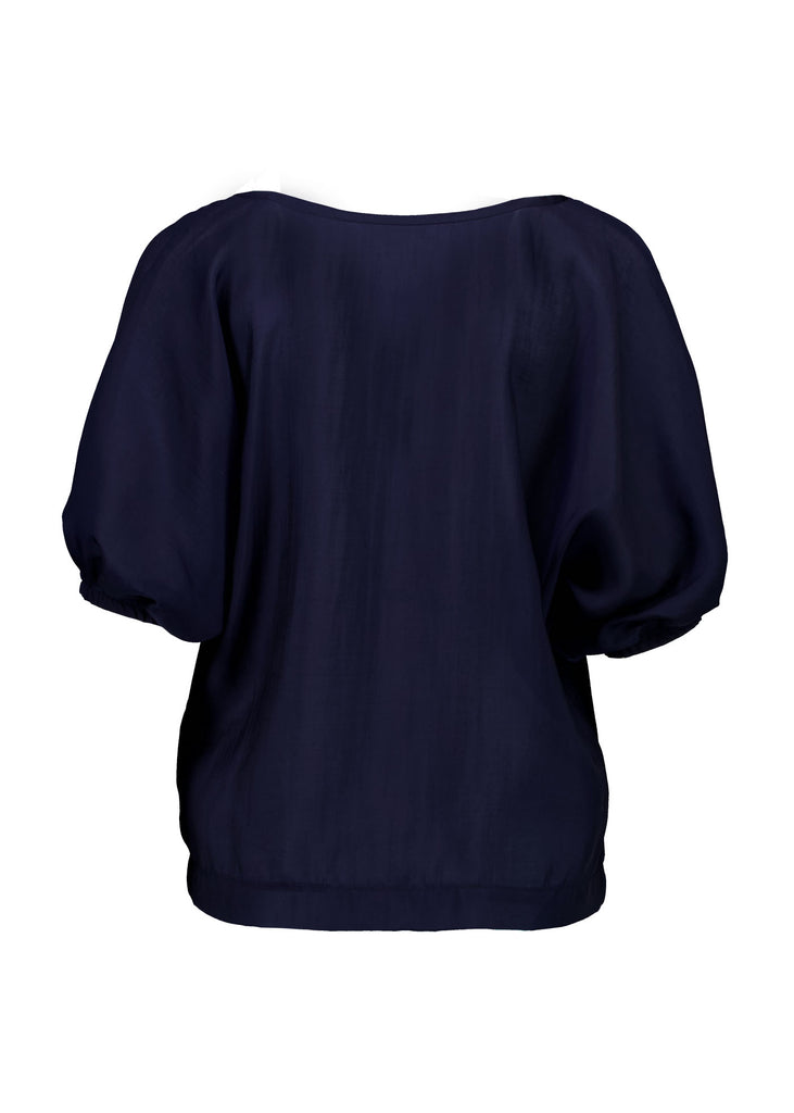 Olga de Polga Skyscraper Camisa blouse in Navy. Reversible top with a soft v-neck on one side and a boat neck on the other. Half sleeves with a bat-wing shape. Back view on model.