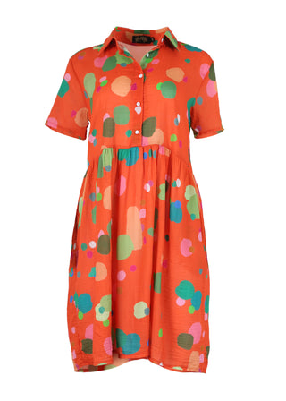 Olga de Polga Villa drop waist dress in Orange Astra printed cotton seersucker. With short sleeves and a collar, with buttons down to the waist, this dress finishes below the knee. Front view.