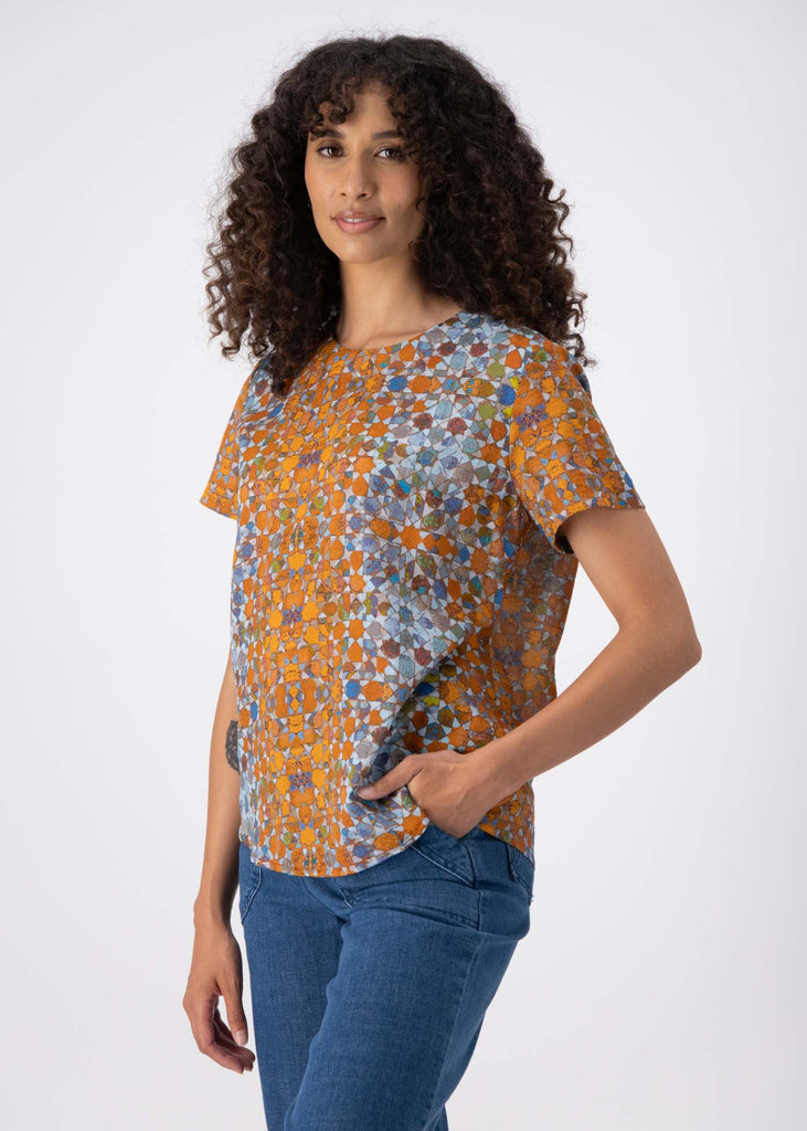 Olga de Polga classic top in our Orange Kaleidoscope printed seersucker. Front view close up. With a round neckline and short sleeves, this boxy top is a great fit for all sizes and shapes, with ample room for a large bust.