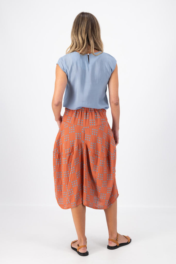 Olga de Polga Milwaukee skirt in Network Orange printed cotton. The Milwaukee is an incredibly unique, chic and original skirt. It is universally flattering, highly versatile, and super comfortable. Perfect to throw on and go. Back view on model.