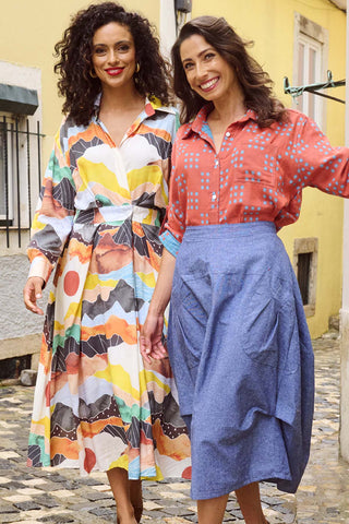 Olga de Polga Orange Vista printed Parisian Dress in 100% Viscose. Front view on model with friend.