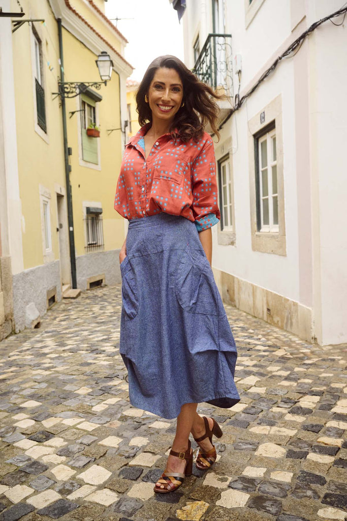 Olga de Polga Network printed cotton shirt in orange with a button down front and collar. 3/4 length sleeves with a foldable sleeve and button fastening. Front view on model.