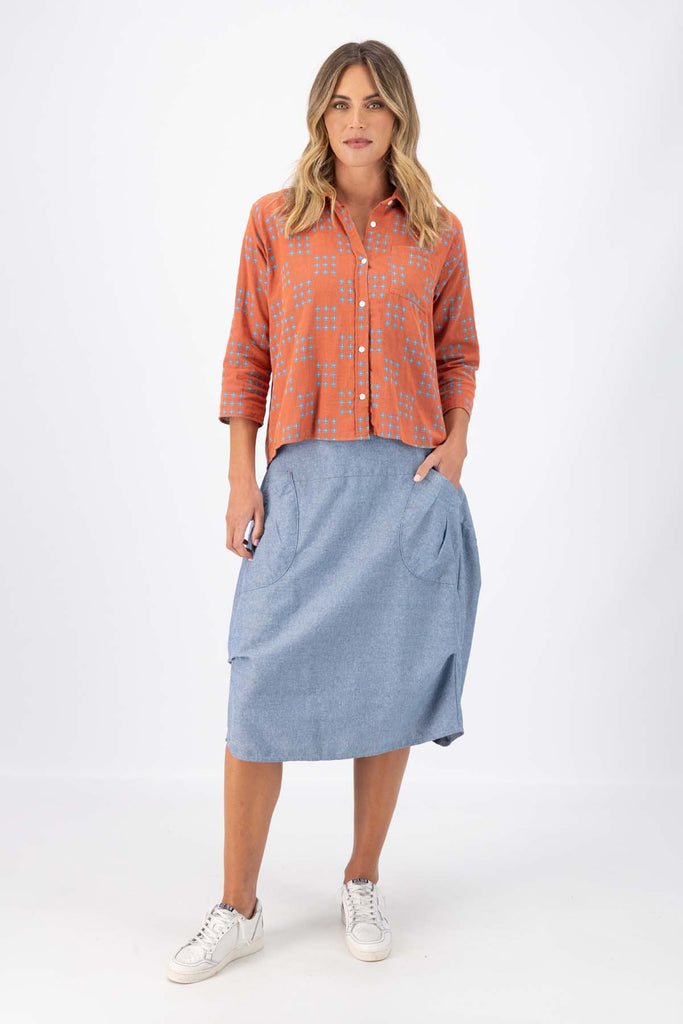 Olga de Polga Network printed cotton shirt in orange with a button down front and collar. 3/4 length sleeves with a foldable sleeve and button fastening. Front full length view on model.