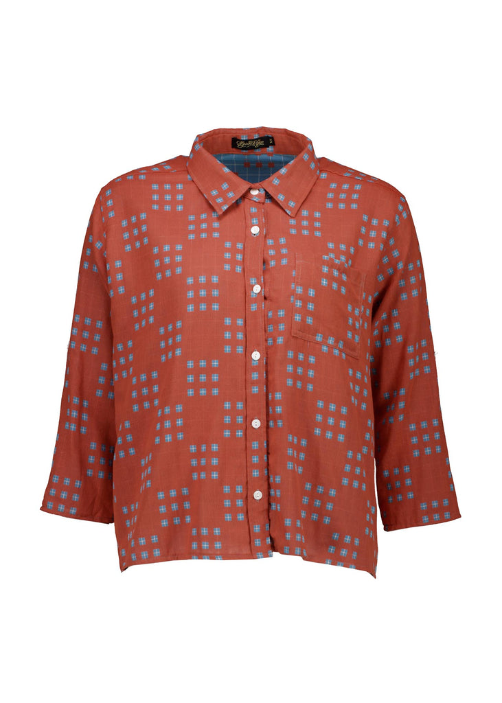 Olga de Polga Network printed cotton shirt in orange with a button down front and collar. 3/4 length sleeves with a foldable sleeve and button fastening. Front view.