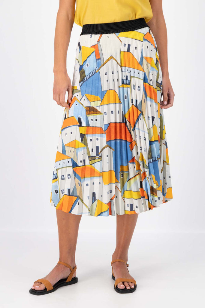 Olga de Polga Pleated skirt in the Pueblito Orange printed recycled polyester. Front close view on model.