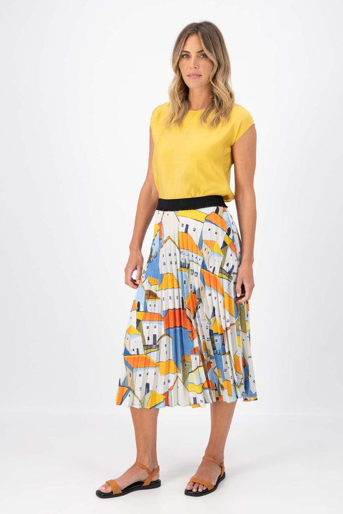 Olga de Polga Pleated skirt in the Pueblito Orange printed recycled polyester. Front view on model.