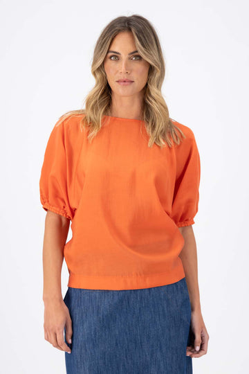 Olga de Polga Camisa Blouse in Orange Skyscraper Tencel. Reversible top with a soft v-neck on one side and a boat neck on the other. Front view on model.