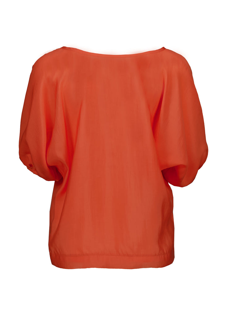 Olga de Polga Camisa Blouse in Orange Skyscraper Tencel. Reversible top with a soft v-neck on one side and a boat neck on the other. Back view on model.