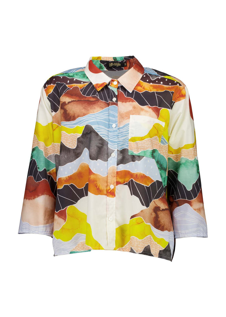 Olga de Polga Orange Vista printed shirt in 100% Cotton. Collar and button down front. 3/4 sleeves. Hip length. Finishes longer at the back. Front view.