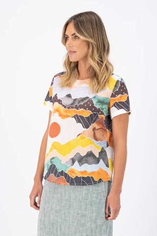 Orange Vista printed Olga de Polga classic Top in cotton seersucker. Round neck with short sleeves and a boxy shape. Side Front view on model.