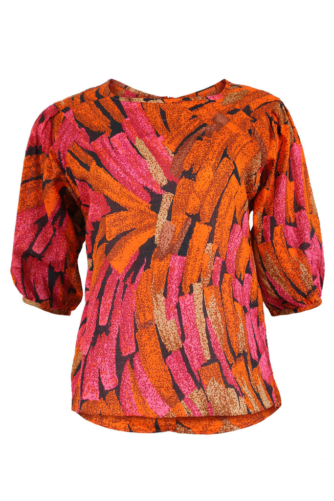 Olga de Polga classic blouse in our Orange Vivant printed cotton seersucker. With a round neck and half sleeves, this blouse finishes at the hem. Front view.