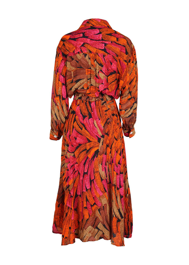 Olga de Polga Parisian Wrap-dress in Orange Vivant printed Viscose. This is a midi dress with long sleeves and a collar. Button detailing at the waist.  Back view