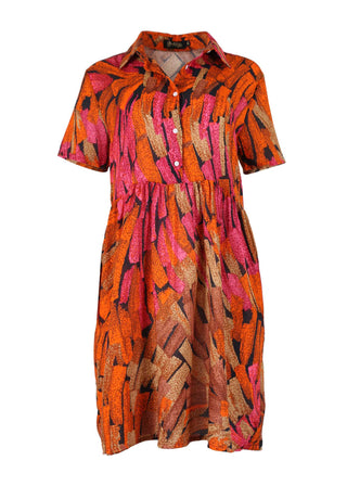 Olga de Olga Villa drop waist dress in Orange Vivant printed cotton seersucker. With a collar button up front going down to the waist, and short sleeves, this dress finishes below the knee.  Front view.