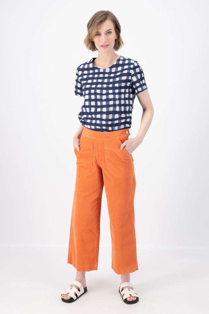 Olga de Polga Peggy Pants in Peach Fine Cotton Cord. Best seller with large front patch pockets, elasticated waistband, cropped length, side zip fastening. Front view on model.