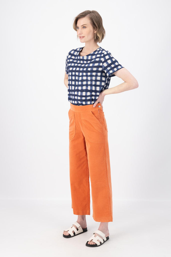 Olga de Polga Peggy Pants in Peach Fine Cotton Cord. Best seller with large front patch pockets, elasticated waistband, cropped length, side zip fastening. Side view on model.