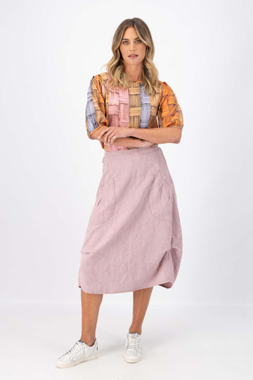 Olga de Polga Milwaukee del arte skirt in baby pink textured cotton/linen. Front full view on model.